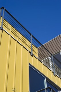 Exterior Detail of Modern Home and Balcony with Yellow Wall