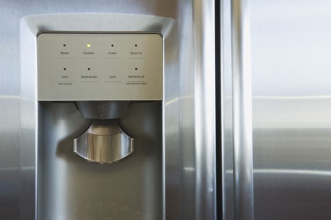 Detail of refrigerator door with water and ice dispenser