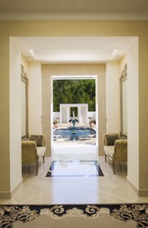 Interior of a marble hallway leading to a pool