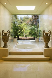 Marble steps leading to an elegant hot tub bathtub