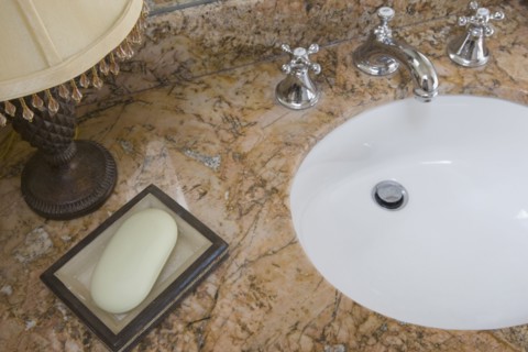 Detail of bathroom sink with chrome faucet and soap dish