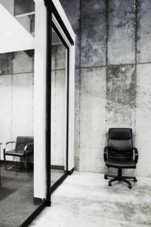 Detail of a lone leather office chair in modern office building