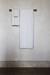 Detail of white towels on a towel rack
