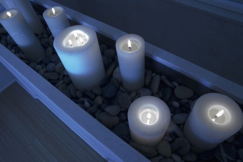 Night scene with lit candles in stones