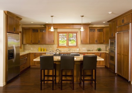 Interior of a large kitchen with wooden floors and cabinetry