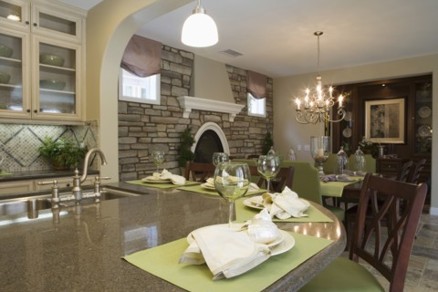 Kitchen with breakfast bar and dining room with stone wall
