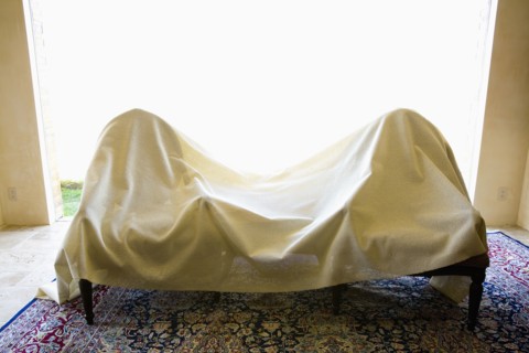 Two chairs covered in a white sheet