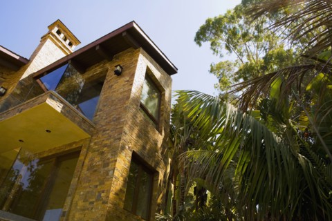 Rear exterior of a large tuscan style home