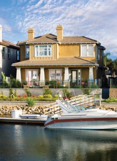 Exterior of one story house with speedboat in lake