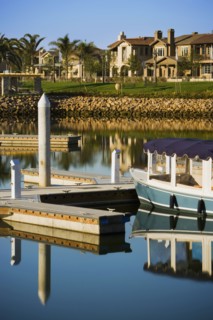 Boats docked at housing community near channel to ocean