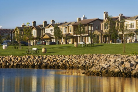 View of contemporary housing community from across channel