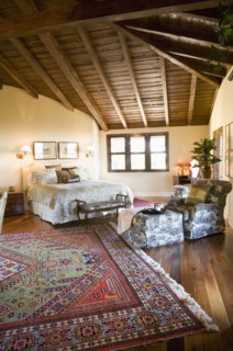 Large master bedroom with vaulted ceilings and area rug