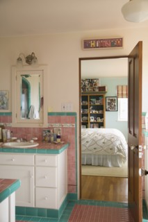 Pink and blue tiled bathroom between bedrooms