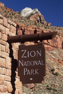 Close up of Zion National Park sign on stone wall