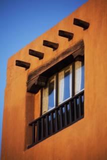 Low angle view of posts and window in adobe house