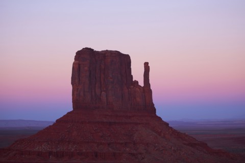 Butte rock formation in desert landscape