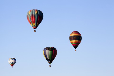 Hot air balloons floating in blue sky