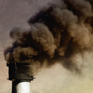 Close up of smoke billowing from smoke stack
