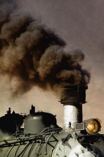 Close up of billowing smoke stack on train