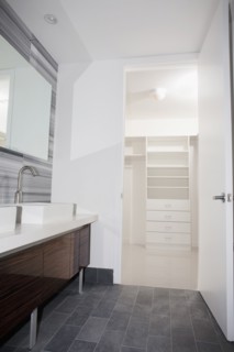 Door open to walk-in closet from modern bathroom