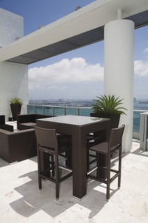 Table and chairs on modern balcony