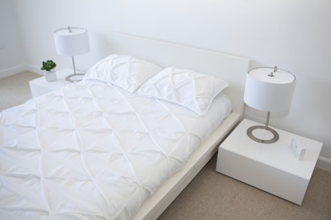 High angle view of bed and night tables in modern bedroom