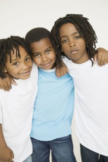 Three African brothers hugging