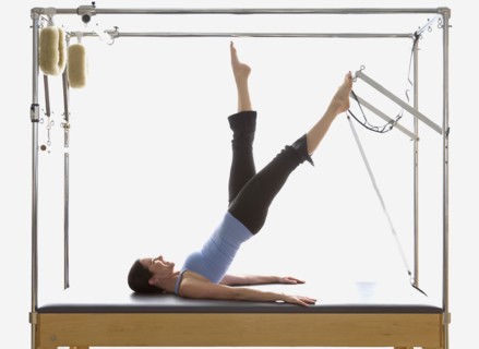 Woman stretching on exercise equipment