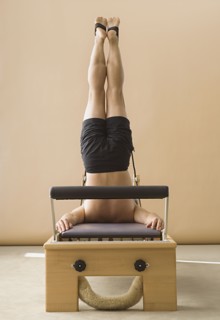 Asian man stretching on exercise equipment