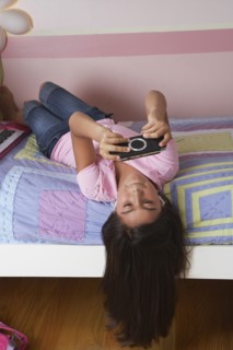 Hispanic girl playing video game