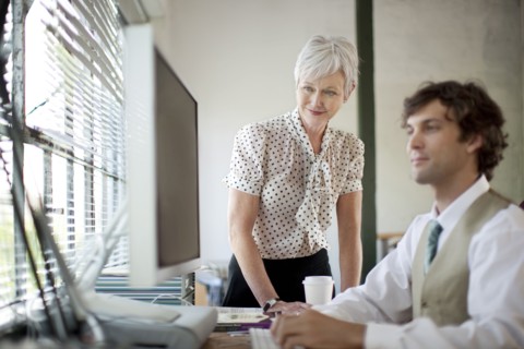 Business people using computer in office