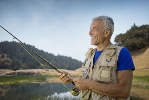 Caucasian man fishing at river