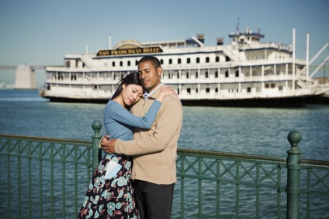 Couple hugging at waterfront near boat