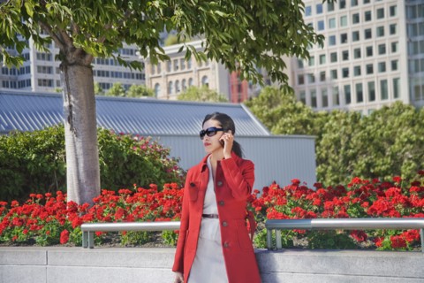 Asian businesswoman talking on cell phone outdoors