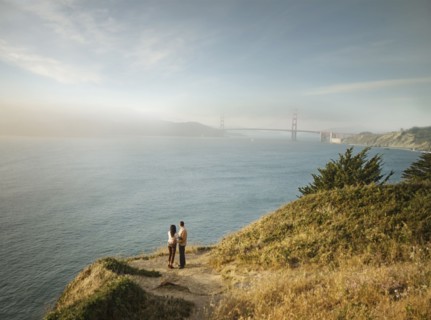 Couple admiring scenic view of bay