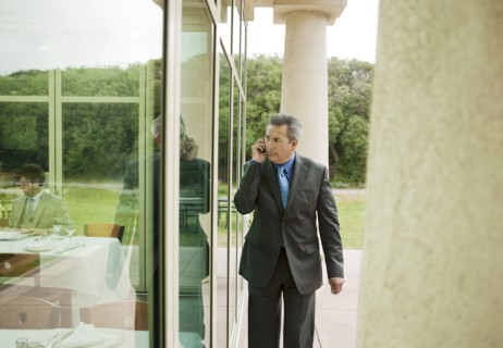 Suspecting Hispanic businessman talking on cell phone