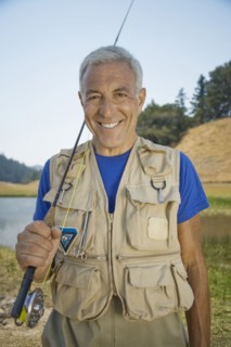 Portrait of smiling Caucasian man holding fishing rod