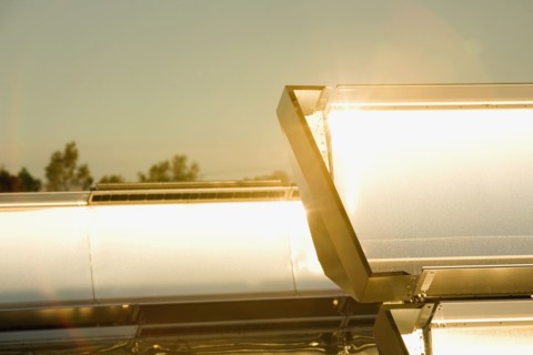 Close up of sun shining on solar panels