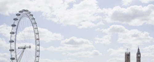 London Eye and clock towers in blue sky