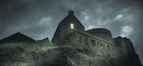 Low angle view of castle on rocky hill