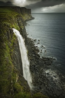 Waterfall over rural coastline