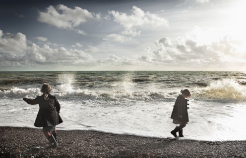 Children playing on rocky beach