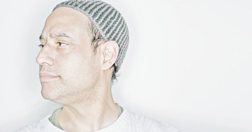 Mixed race man wearing cap