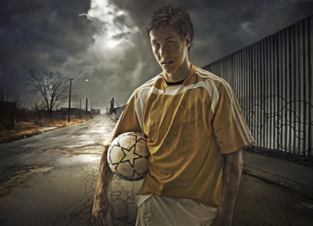 Illustration of soccer player holding ball on city street