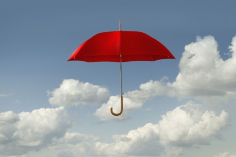 Red umbrella floating in clouds