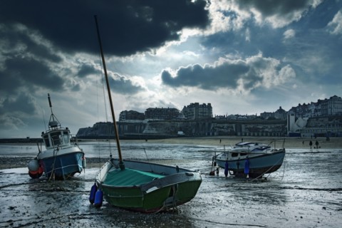 Boats stranded on urban beach