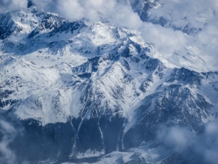 Clouds and snow covered mountains