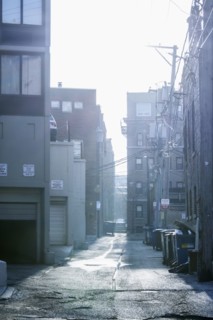 Garbage cans in urban alleyway