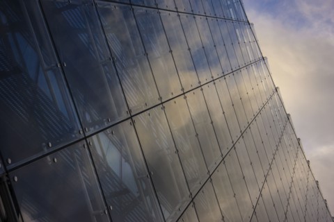 Close up of clouds reflected in windows of highrise