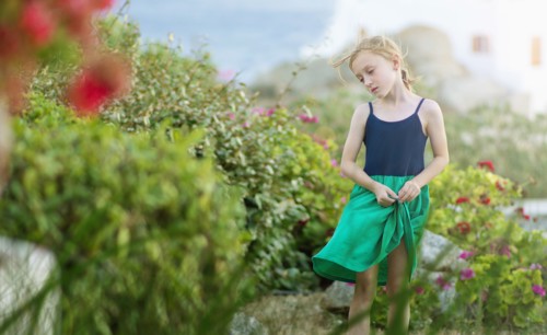 Caucasian girl walking in field of flowers